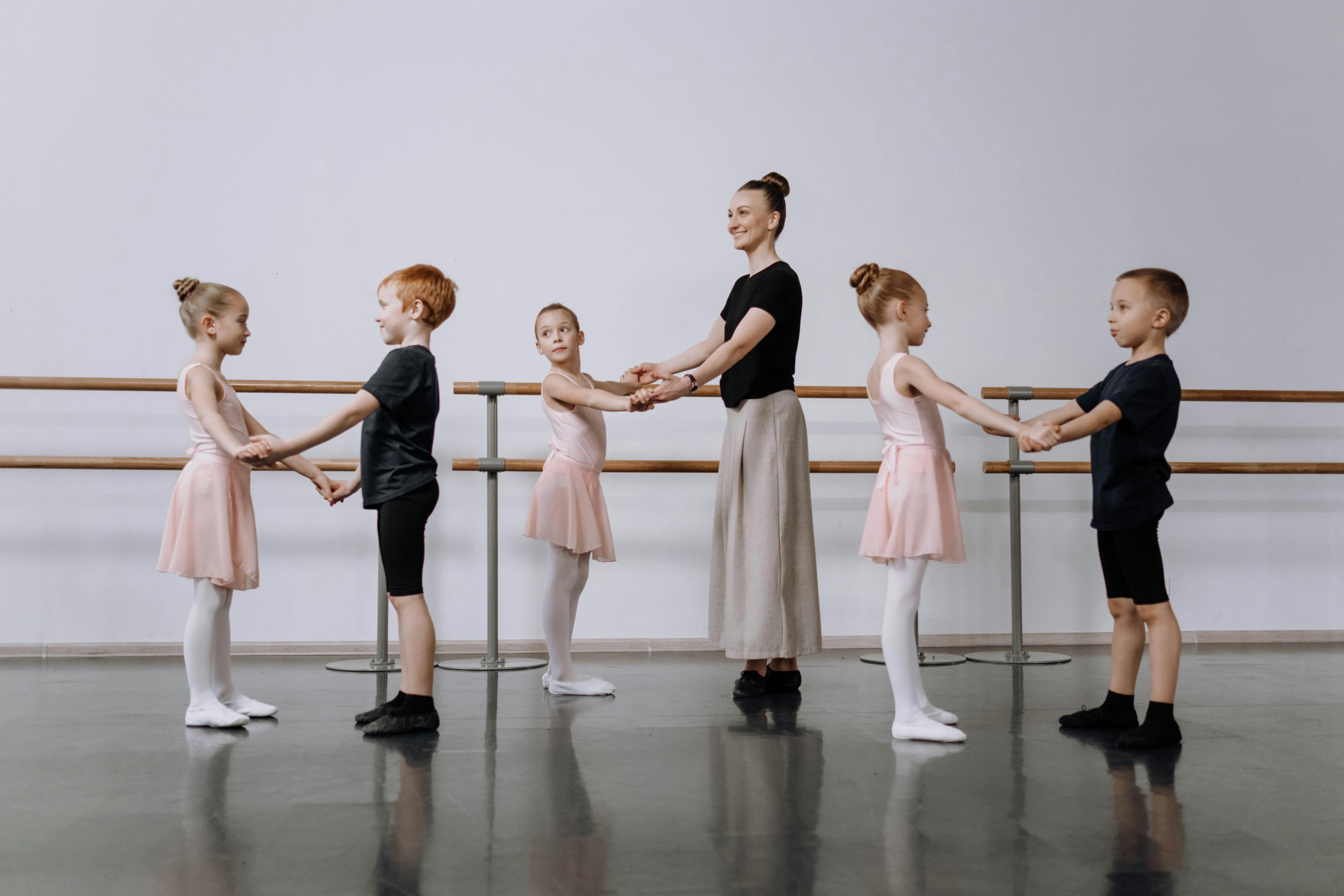 Ballet teacher with young dance students at practice